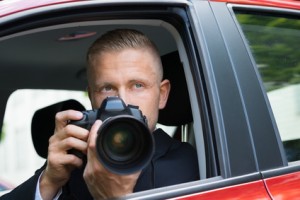Close-up Of A Male Driver Photographing With Slr Camera From Car